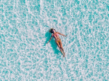 Photo of a woman on her back floating in water