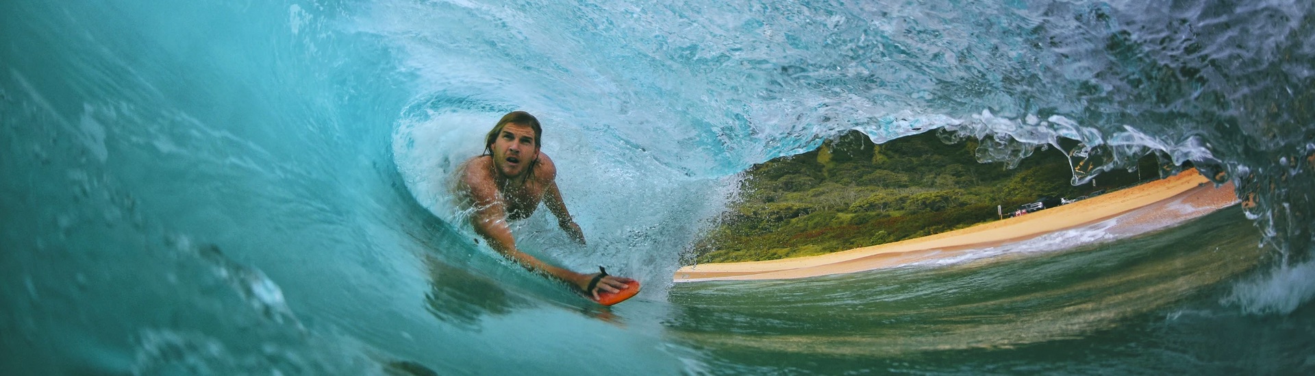 Picture of swimmer paddling through a wave